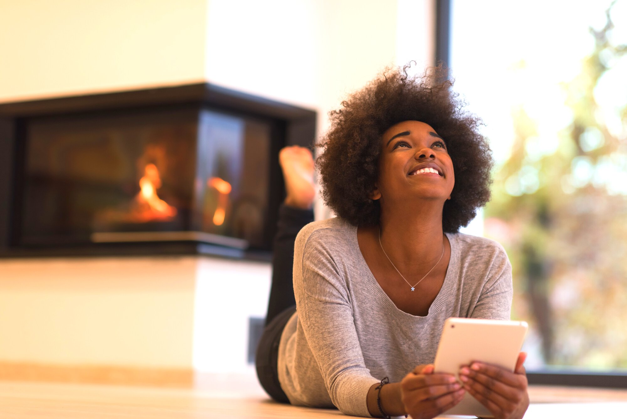 Black Women Using Tablet Computer on the Floor