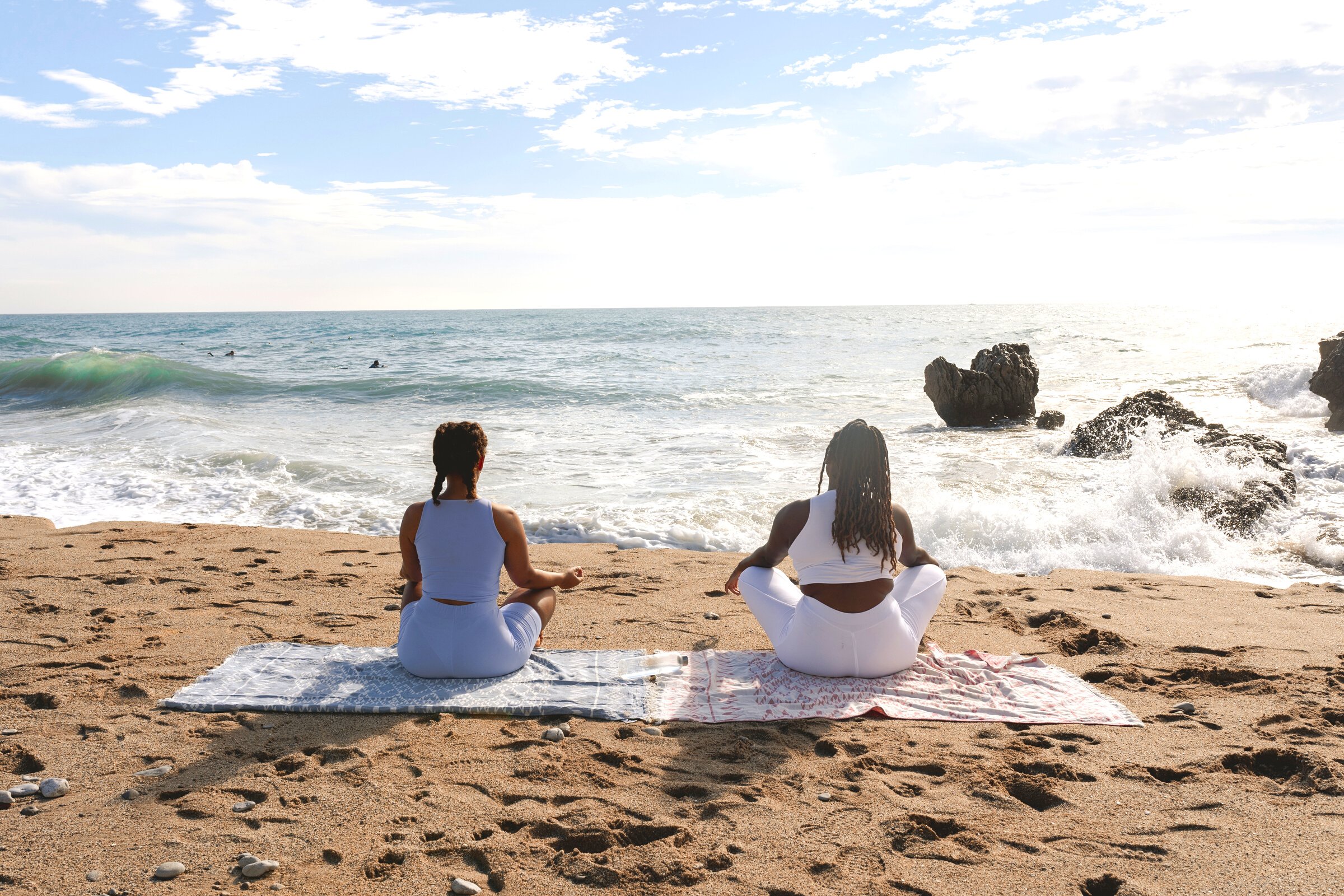 Women Meditating at the Beach